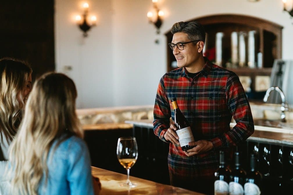 A tasting room associate greets visitors to the DAOU Estate